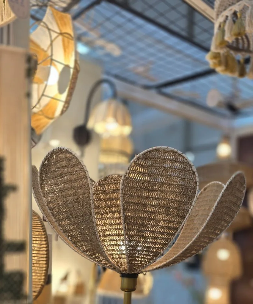 Flower-shaped woven lamp among other lit lamps.