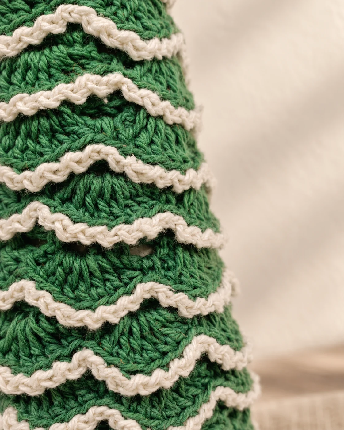 Close view of the layered crochet and white ruffles on the green Christmas tree.