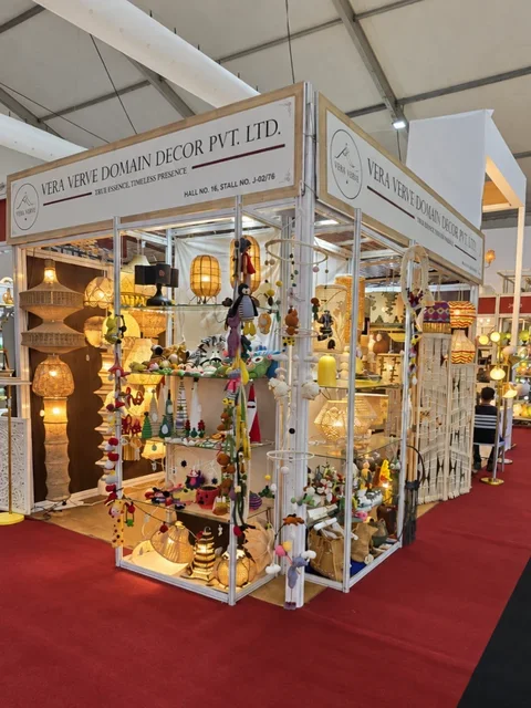 The Vera Verve stall in Hall 16 at IHGF Delhi Fair Autumn 2025, with crochet lamps and décor on glass shelves.