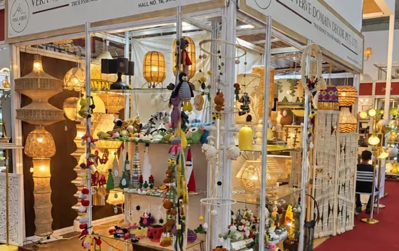 The Vera Verve stall in Hall 16 at IHGF Delhi Fair Autumn 2025, with crochet lamps and décor on glass shelves.