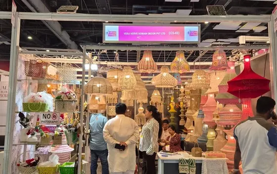 Visitors looking at crochet lamps and baskets inside the Vera Verve stall at Bharatiya Vyapar Mahotsav 2026.