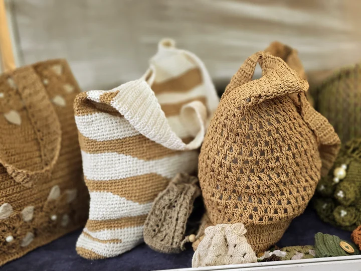 Crochet bags in natural, cream and olive yarns displayed at our stall, IHGF Delhi Fair Autumn 2025.